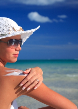Woman enjoying summer sun on the beach